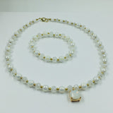 White and gold glass beaded necklace with matching bracelet set.