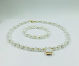 White and gold glass beaded necklace with matching bracelet set.